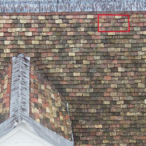 Close up of roof tiles at St Catharine's College with missing tile highlighted with red rectangle