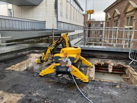 Robot demolishing roof of the College's old Hall