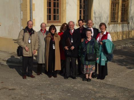 Dr Gilly Carr with a group of former internees at Compiegne Memorial in 2008, standing outside one of the former buildings of the camp
