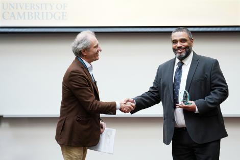 Malik Al Nasir accepts the Vice Chancellor's 2023 Global Impact Award from Professor Anthony Freeling