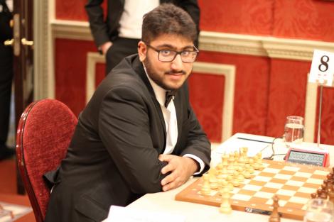 Omeet Atara sat with chess board at 2023 Varsity Match