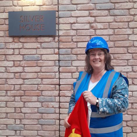 Professor Katharine Dell, President of St Catharine's College, with a sign for Silver House