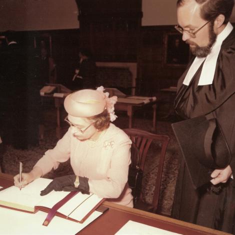 Queen Elizabeth II signing the St Catharine's visitor book with Professor Sir John Baker