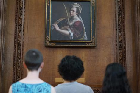 St Catharine's students with the reproduction of Artemisia Gentileschi's Self Portrait as Saint Catherine of Alexandria in the College's Chapel