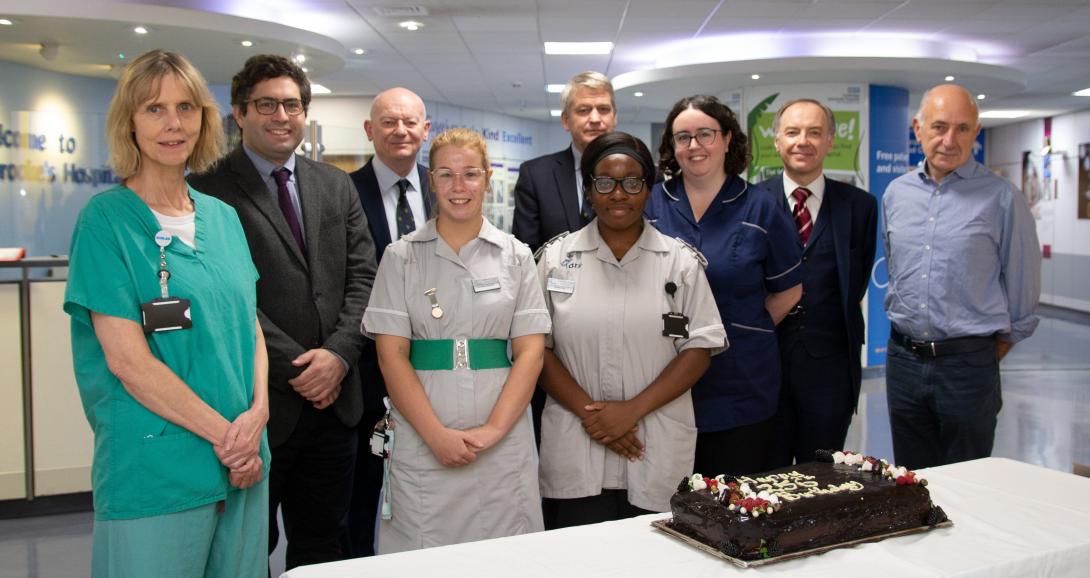 St Catharine's Fellows and Addenbrooke's Hospital staff with a 256th birthday cake