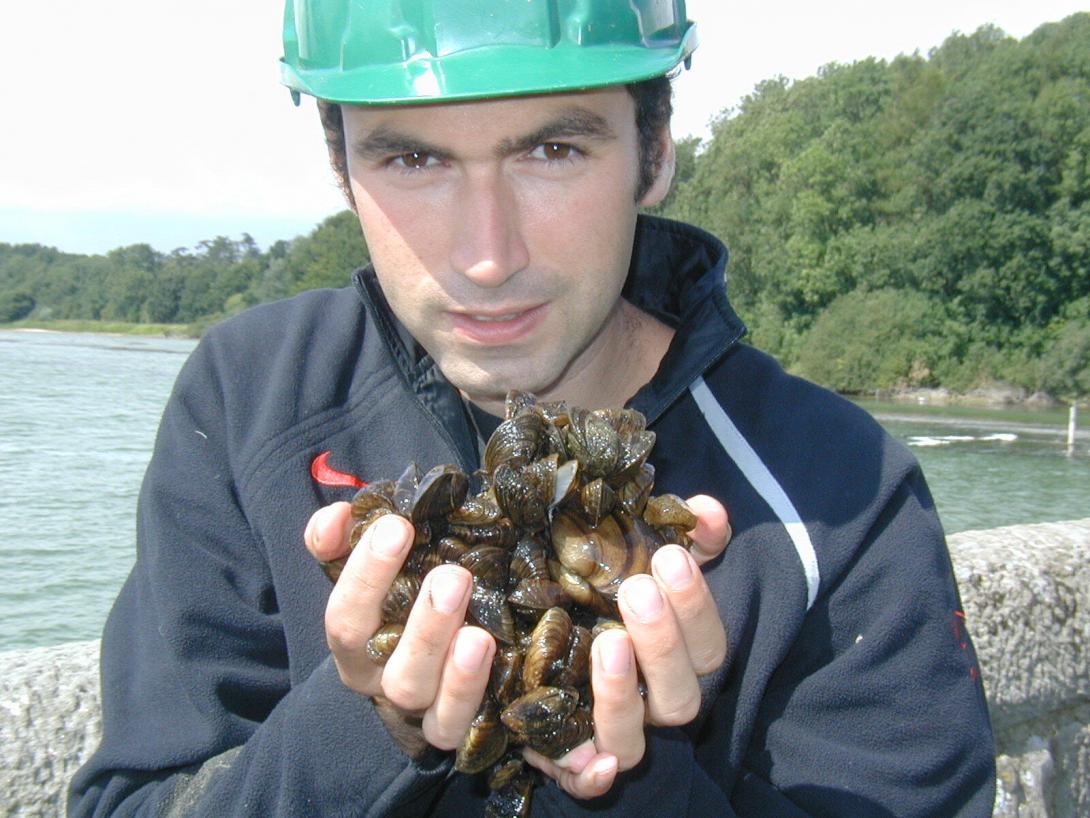 David Aldridge holding zebra mussels 