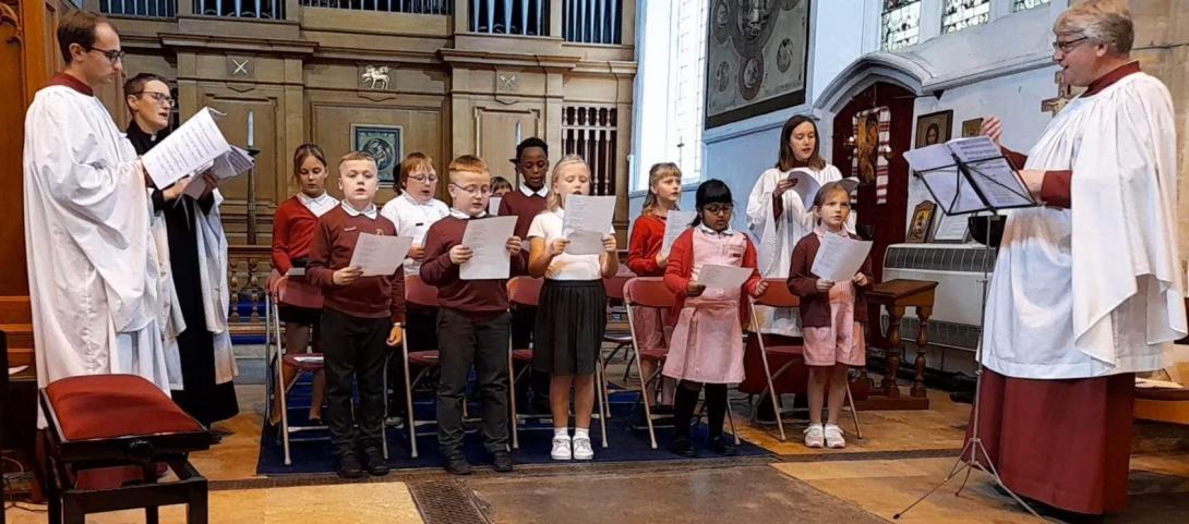 Elm Road Primary School choir sing during a service at the Church of St Peter and St Paul in Wisbech, with representatives from St Catharine's