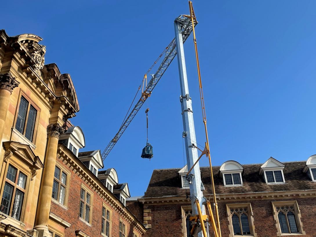 Crane transporting load above D staircase and the old Hall at St Catharine's